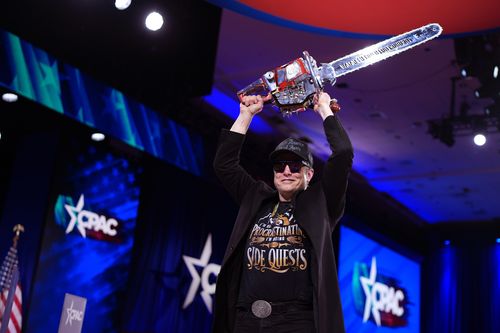 OXON HILL, MARYLAND - FEBRUARY 20: CEO of Tesla and SpaceX Elon Musk leaves the stage holding a chainsaw after speaking at the Conservative Political Action Conference (CPAC) at the Gaylord National Resort Hotel And Convention Center on February 20, 2025 in Oxon Hill, Maryland. The annual four-day gathering brings together conservative U.S. lawmakers, international leaders, media personalities and businessmen to discuss and champion conservative ideas. Argentinian President Javier Milei gifted M