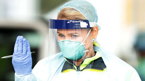 A medical professional communicates with a driver at the COVID-19 Bondi Beach drive-through testing centre on July 07, 2020 in Sydney, Australia. 