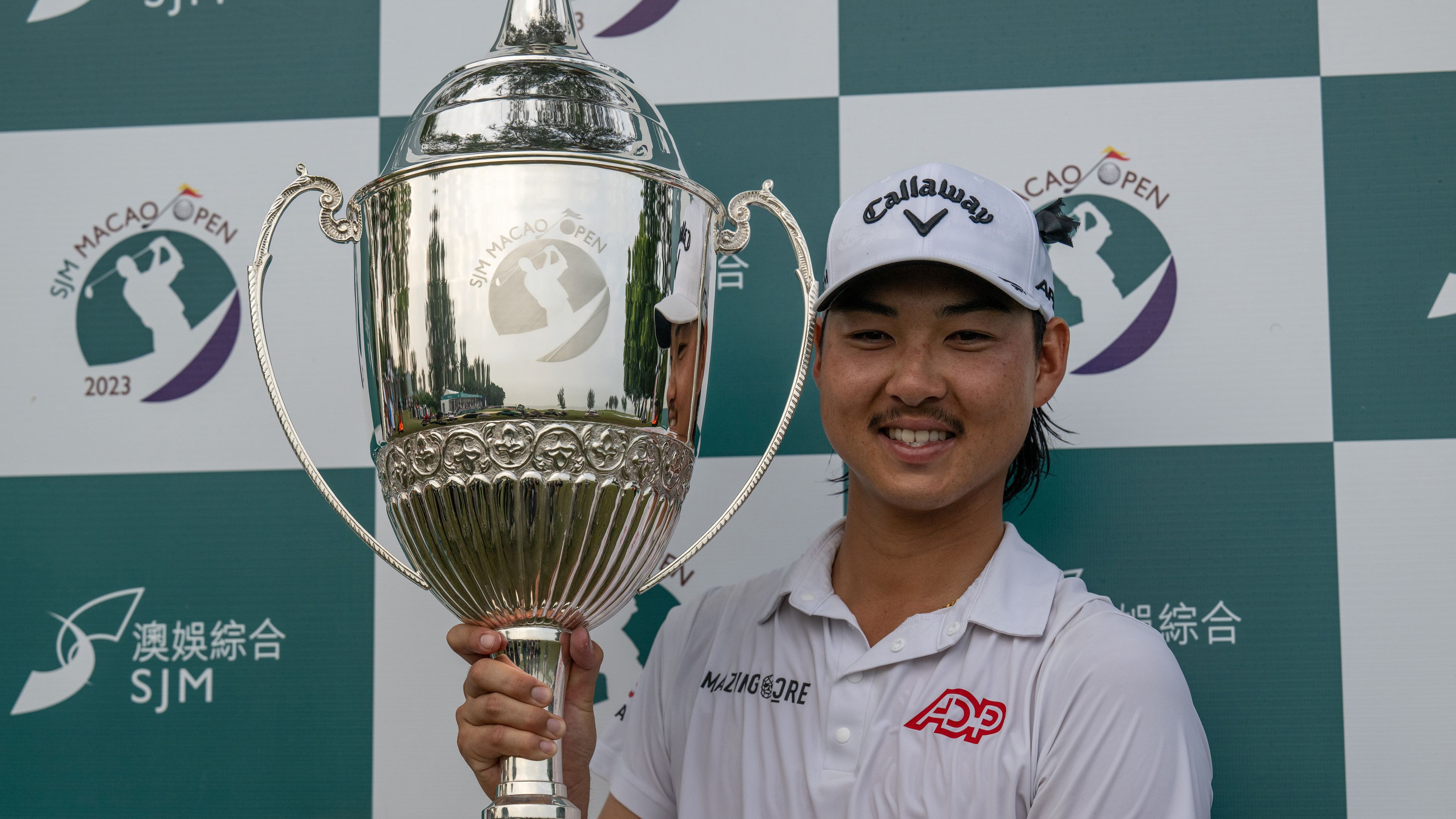Australia&#x27;s Min Woo Lee poses with the winner&#x27;s trophy after triumphing at the Macau Open.