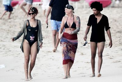 Rihanna visited family and friends in Barbados. And her bodyguard (the blonde) even flashed the paparazzi!