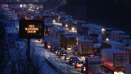 The scene on the M80 Haggs in Glasgow, as the highest level of weather warning has been issued for Scotland and Ireland as forecasters warn of blizzard-like conditions. (AAP)
