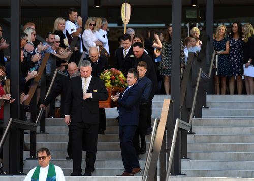 Pall-bearers, including 13-year-old Brayden, carry the coffin of his father Dean Mercer. (AAP)