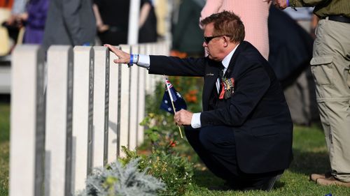 A mourner visits a grave in Beersheba today. (AAP