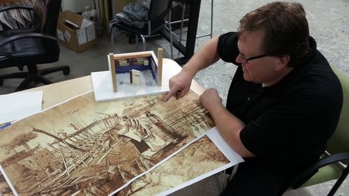 A member of the Ark Encounter design team shows plans for a Biblical scene set to feature as a theme park exhibit. (Ark Encounter)