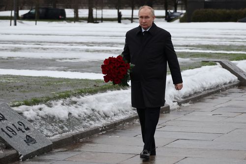 Russian President Vladimir Putin attends events marking the 80th anniversary of the break of Nazi's siege of Leningrad, (now St. Petersburg) during World War Two at the Piskaryovskoye Memorial Cemetery, where hundreds of thousands of siege victims are buried, in St. Petersburg, Russia, Wednesday, Jan. 18, 2023. 