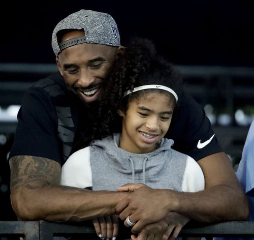 In this 2018 photo former Los Angeles Laker Kobe Bryant and his daughter Gianna are pictured at the US national championships swimming meet. The 18-time NBA All-Star who won five championships and became one of the greatest basketball players of his generation during a 20-year career with the Los Angeles Lakers, died in a helicopter crash on Sunday. Gianna also died in the crash. She was 13.
