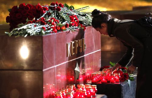 Mourners were seen laying flowers at a monument to the city of Kerch.