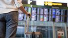 Woman at airport looking at flight board