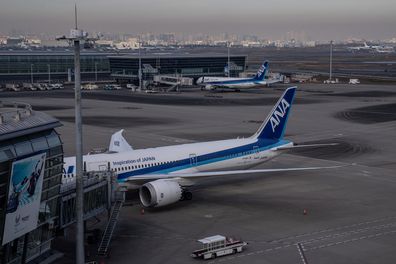 Aeroplanes sit on the tarmac at Haneda Airport