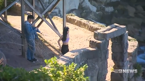 Even in the hours after a woman fell to her death, people were at the cliff edge taking photos.