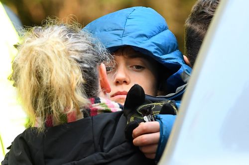 William Callaghan is hugged by his mother at the base camp at Mount Disappointment. He was found alive after two cold nights in Victoria's bush