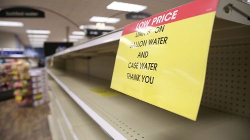 Signs show the limit for water purchases at a Kroger in Jackson, Mississippi.