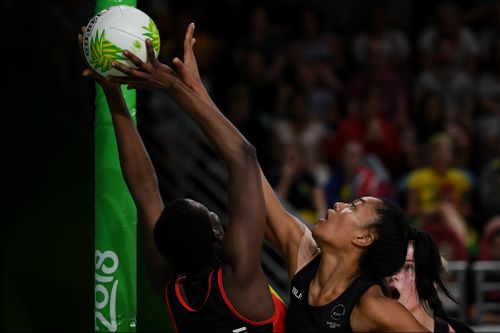 Temalisi Fakahokotau of New Zealand tries to block a shot by Peace Proscovia of Uganda. (AAP)