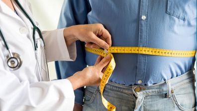 Fat man obese doctor waist measure overweight gut