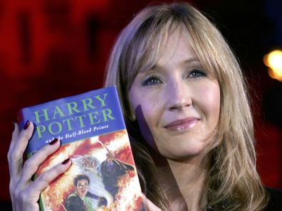 JK Rowling holds a Harry Potter book