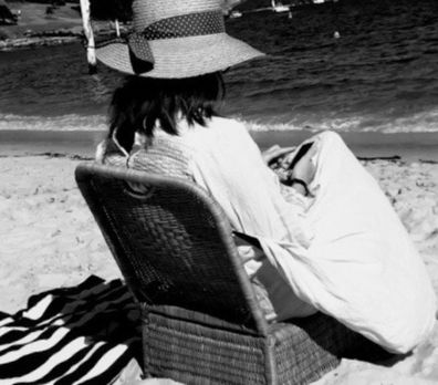 Nikki Gemmell sitting on a chair at the beach