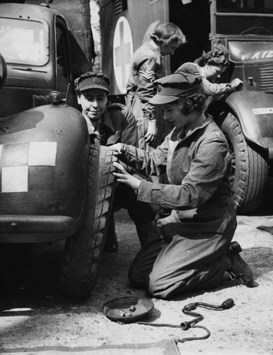 Princess Elizabeth changing the tire of a vehicle as she trains at as ATS Officer during World War Two, at the ATS training centre in England, April 18th 1945. (Photo by Central Press/Hulton Archive/Getty Images)