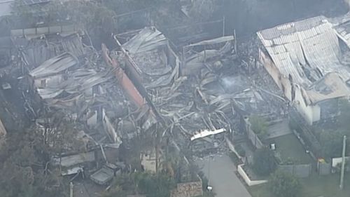 A home lies in ruins in Tathra today after a bushfire raced through the community yesterday, forcing evacuations. Picture: AAP