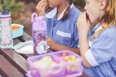 Schoolgirls eating a healthy lunch. 