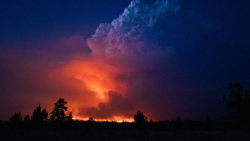 In this photo provided by the Oregon Office of State Fire Marshall, flames and smoke rise from the Bootleg fire in southern Oregon on Wednesday, July 14, 2021. (John Hendricks/Oregon Office of State Fire Marshal via AP)