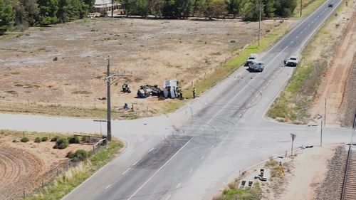 A young woman has been killed and three others are seriously injured after a school bus with no students on board collided with a car north of Adelaide.