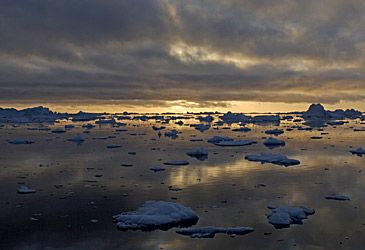 When is the midnight sun visible from the Arctic Circle?