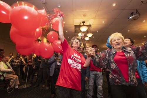 Labor supporters celebrate the victory.