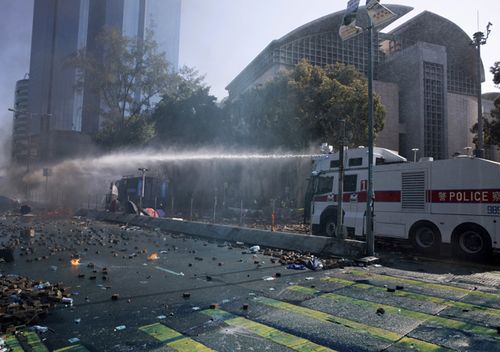 Water cannon trucks drove over bricks and nails strewn by protesters and sprayed them at close range in a bid to drive away protesters on the streets outside the Polytechnic.