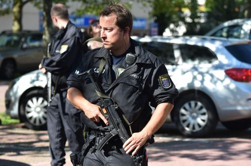A Police man stands near a cinema where an armed man barricaded himself in Viernheim, southern Germany (Getty)