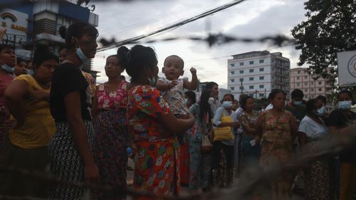 Family members wait for prisoners outside Insein Prison in Yangon. 