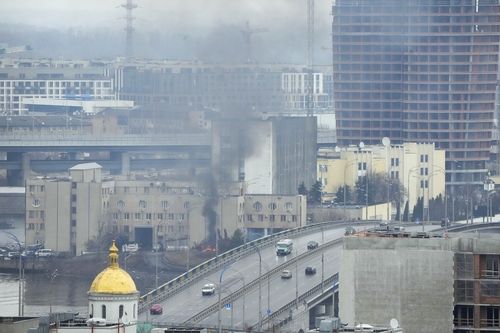 Smoke and flame rise near a military building after an apparent Russian strike in Kyiv, Ukraine, Thursday, Feb. 24, 2022. 