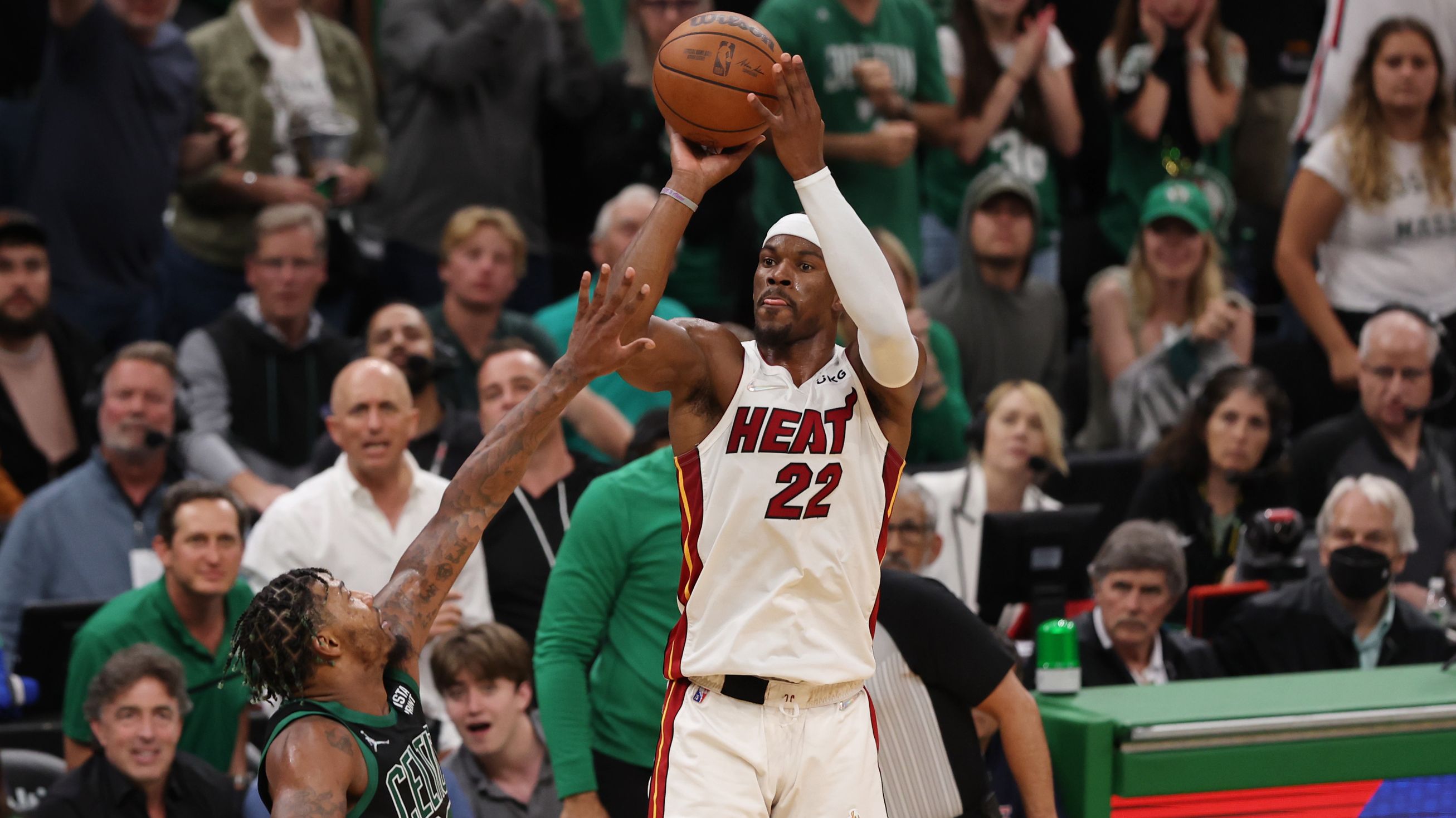 Miami&#x27;s Jimmy Butler shoots a three point basket over Boston&#x27;s Marcus Smart.