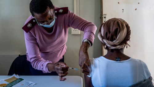 A woman is vaccinated against COVID-19 in Lawley, south of Johannesburg, South Africa.