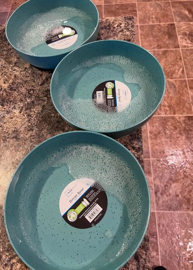 Bowls filled with hot soapy water to help remove label.