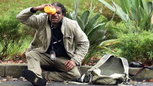A man washes capsicum spray out of his eyes. (AAP)