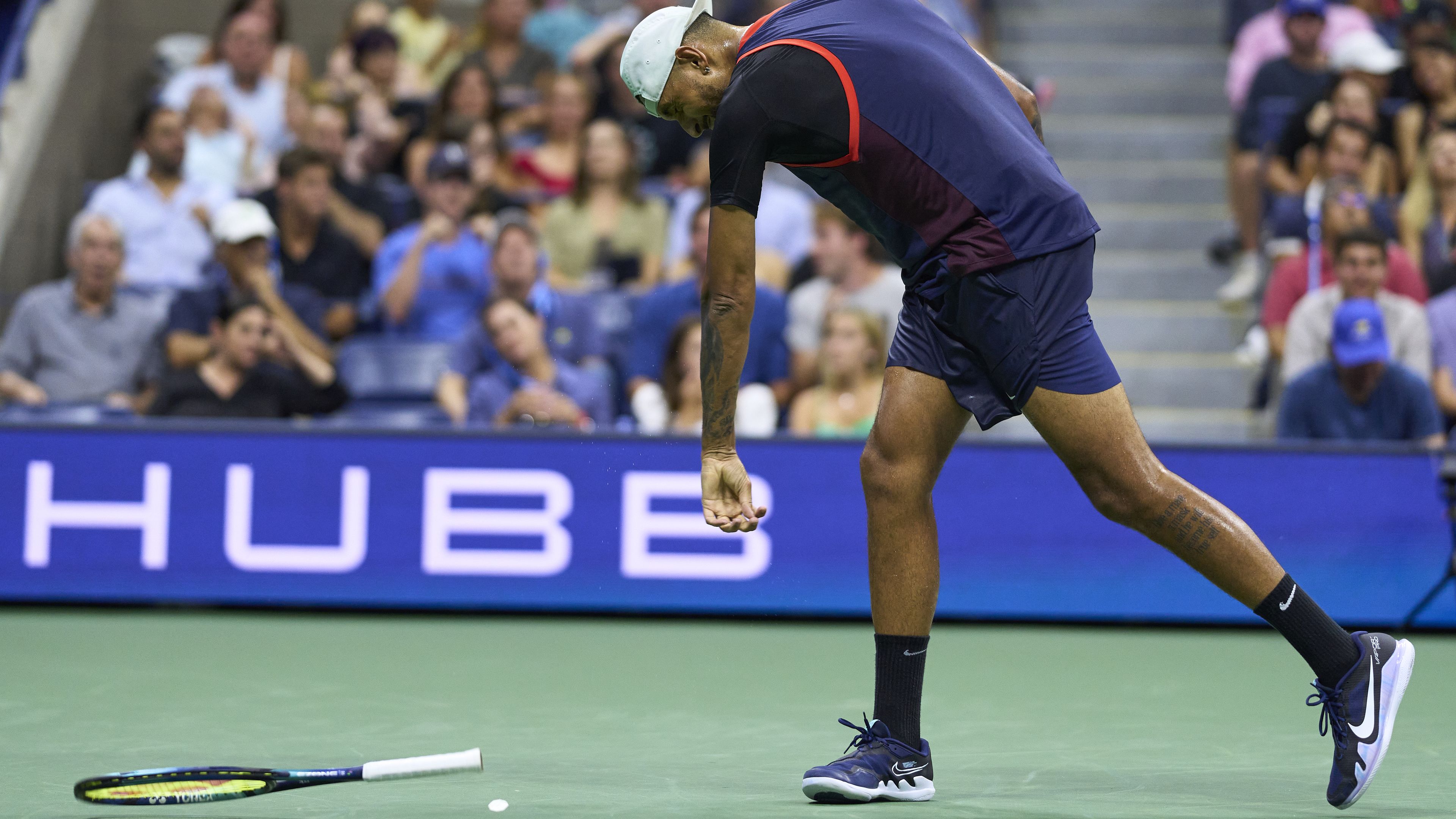 Aussie tennis star Nick Kyrgios throws his racquet into the court during the US Open.