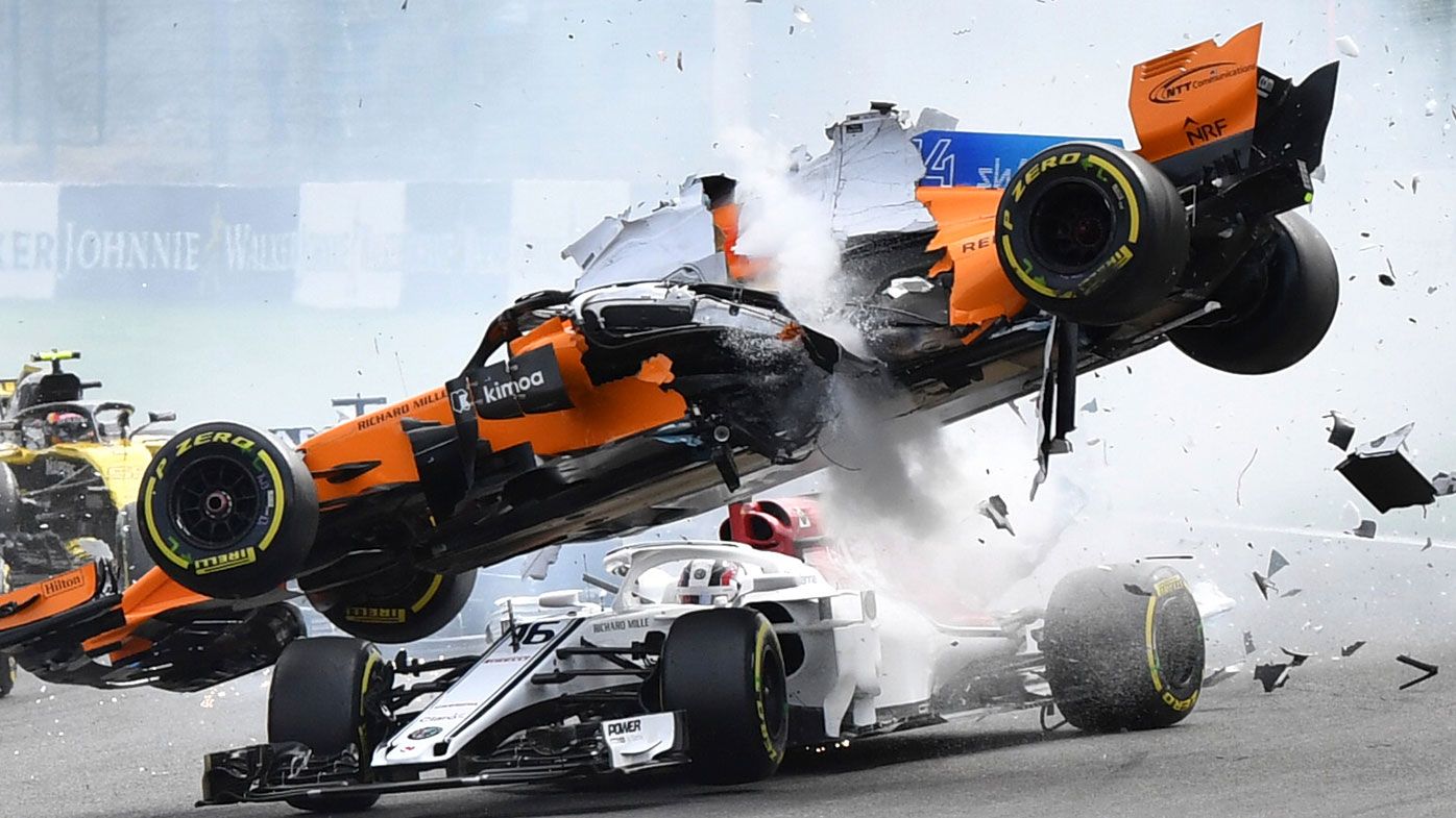 Charles Leclerc is hit by Fernando Alonso at the start of the Belgian Grand Prix.