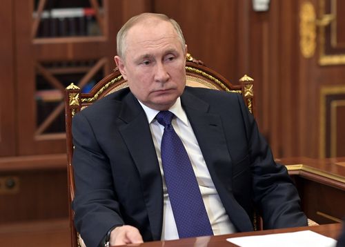 Russian President Vladimir Putin listens to St. Petersburg's governor Alexander Beglov during their meeting in the Kremlin in Moscow, Russia, Tuesday, March 1, 2022.