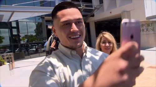 Caleb Maraku laughs and takes selfies outside court after escaping with 12 months' probation and compensation. Picture: 9NEWS