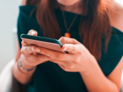 A close-up view of a young woman using her smartphone