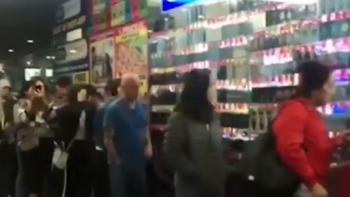 People line up outside a Melbourne chemist to swoop on the baby formula. 