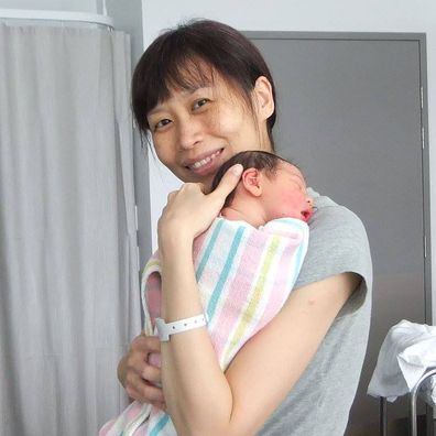 Melody Tan poses with her newborn.