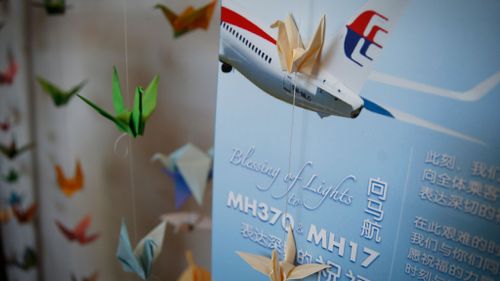 Folded paper cranes are displayed for those who boarded the ill-fated Malaysian Airlines planes, MH370 and MH17, at Xiao En Bereavement Care Centre in Kuala Lumpur, Malaysia. (Picture: AAP)