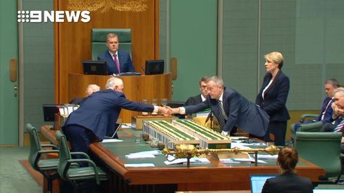 Malcolm Turnbull and Bill Shorten shake hands in a show of unity against Senator Anning's comments last night. (Nine)