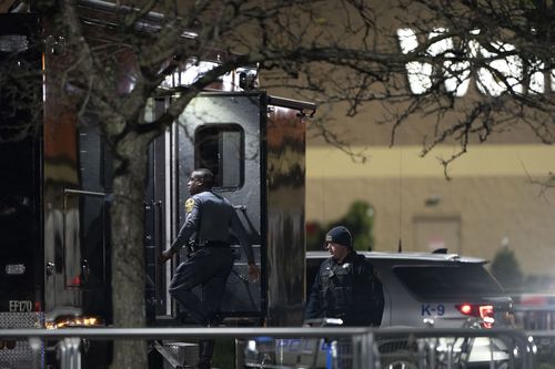 Law enforcement enter a command vehicle as they work the scene of a mass shooting at a Walmart, Wednesday, November 23, 2022, in Chesapeake, Virginia