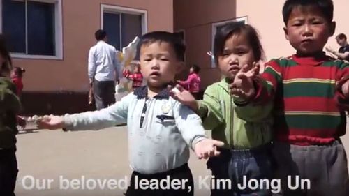 A screen shot of children in North Korea dancing while singing about their "beloved leader". (YouTube)