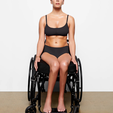 Disabled woman models the Skims collection in her wheelchair