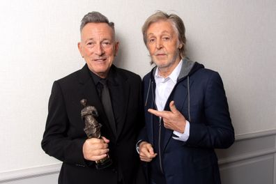 Bruce Springsteen, holding his Ivor Award, poses with Sir Paul McCartney at the Ivor Novello Awards in London on Thursday, May 23.