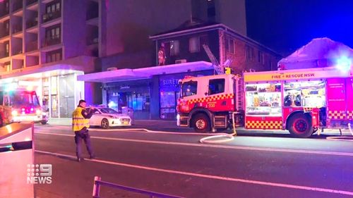 Firefighters who heard screams had to force open the door of a locked room to rescue three teenagers from a burning apartment in Sydney.