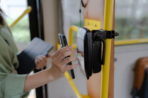 Woman using card to tap onto public transport